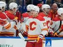 Calgary Flames forward Yegor Sharangovich (17) celebrates with the bench after scoring against the Tampa Bay Lightning during the second period of an NHL hockey game Thursday, March 7, 2024, in Tampa, Fla.