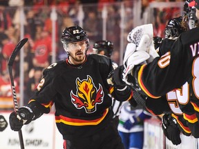 Calgary Flames celebrates with the bench after scoring against the Vancouver Canucks during the first period of an NHL game at Scotiabank Saddledome