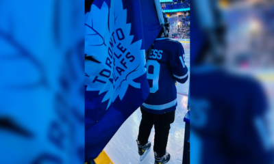 Young First Nations hockey player carries Leafs' flag