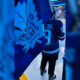 Young First Nations hockey player carries Leafs' flag