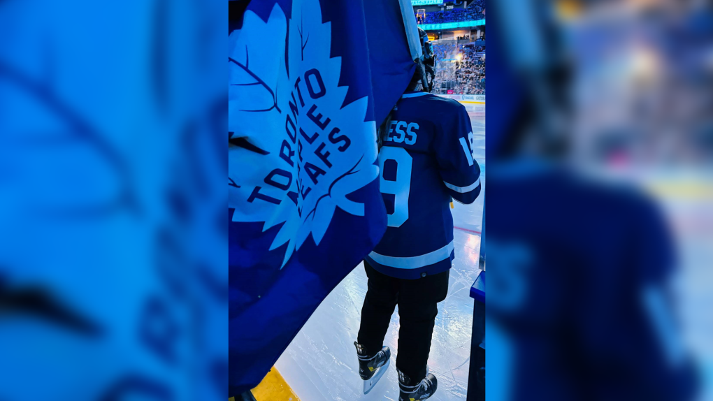 Young First Nations hockey player carries Leafs' flag