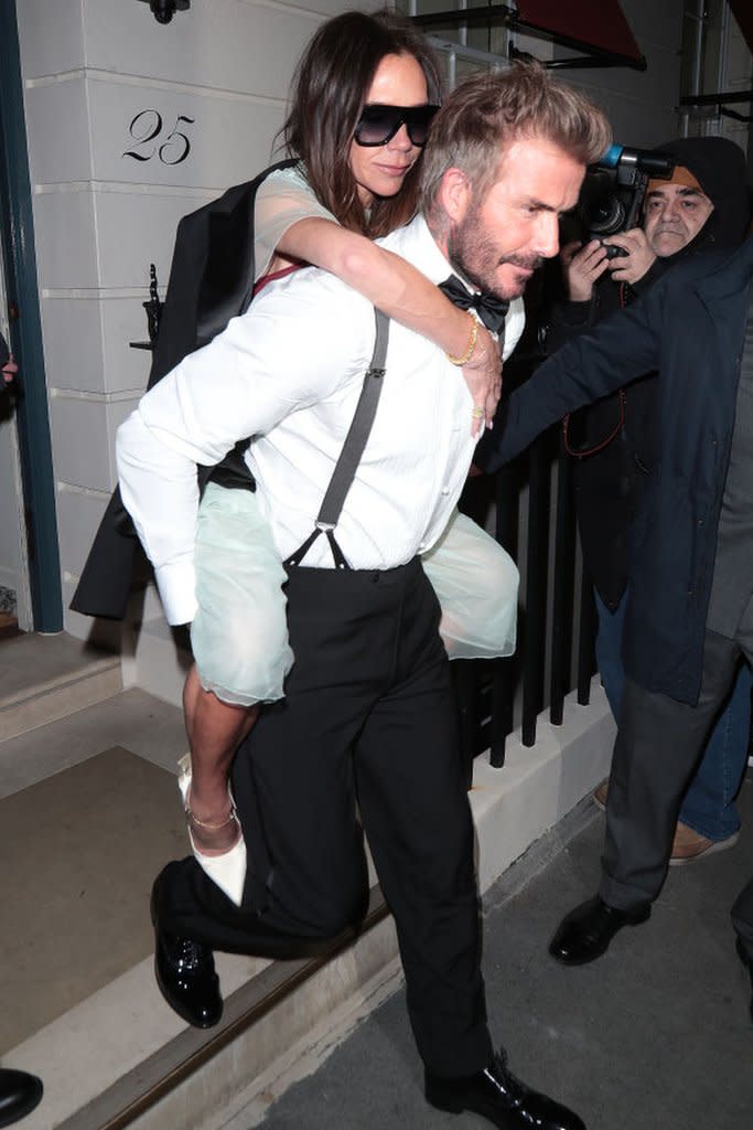 David Beckham carrying Victoria out of the party