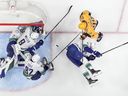 Vancouver Canucks goaltender Arturs Silovs, J.T. Miller, Ian Cole and Tyler Myers  defend the goal against Nashville Predators' Ryan O'Reilly  during the third period in Game 6 of an NHL hockey Stanley Cup first-round playoff series Friday, May 3, 2024, in Nashville, Tenn.