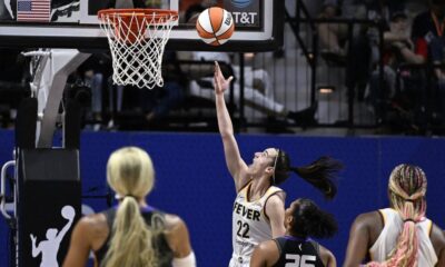 Indiana Fever guard Caitlin Clark (22) scores her first career basket against the Connecticut Sun on May 14, 2024. (Jessica Hill/AP Photo)