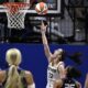 Indiana Fever guard Caitlin Clark (22) scores her first career basket against the Connecticut Sun on May 14, 2024. (Jessica Hill/AP Photo)