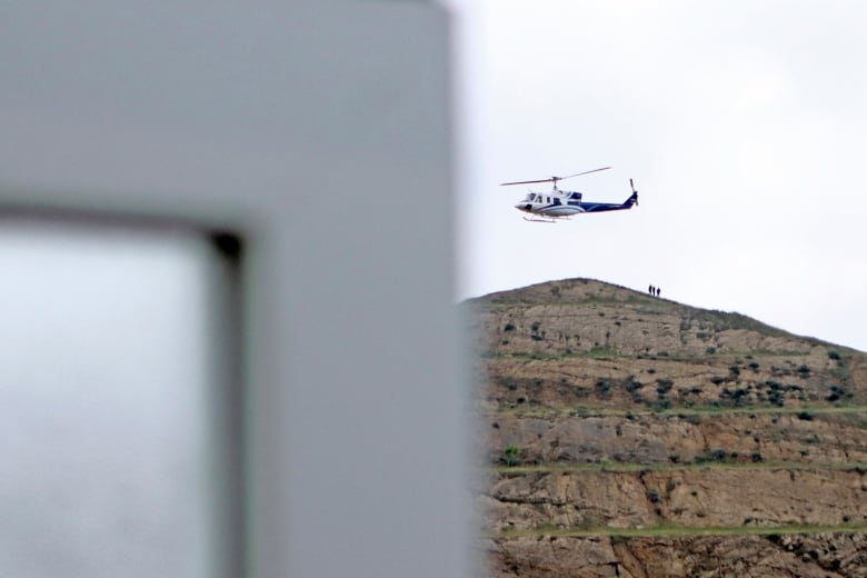 A helicopter is seen flying.