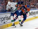 The Edmonton Oilers' Leon Draisaitl  battles the Vancouver Canucks' Tyler Myers  during game at Rogers Place in Edmonton  May 18.