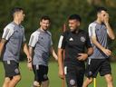 Inter Miami forward Luis Suarez, left, walks with Lionel Messi, centre and defender Sergio Busquets, right, during a training session. It was only after Thursday's practice that Miami ruled the star trio out for Saturday's game. 
