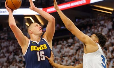 The Denver Nuggets' Nikola Jokic (15) goes to the basket against the Minnesota Timberwolves' Karl-Anthony Towns.