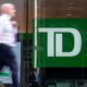 A person makes their way past a Toronto-Dominion Bank in the Financial District of Toronto on August 14, 2023. THE CANADIAN PRESS/Spencer Colby