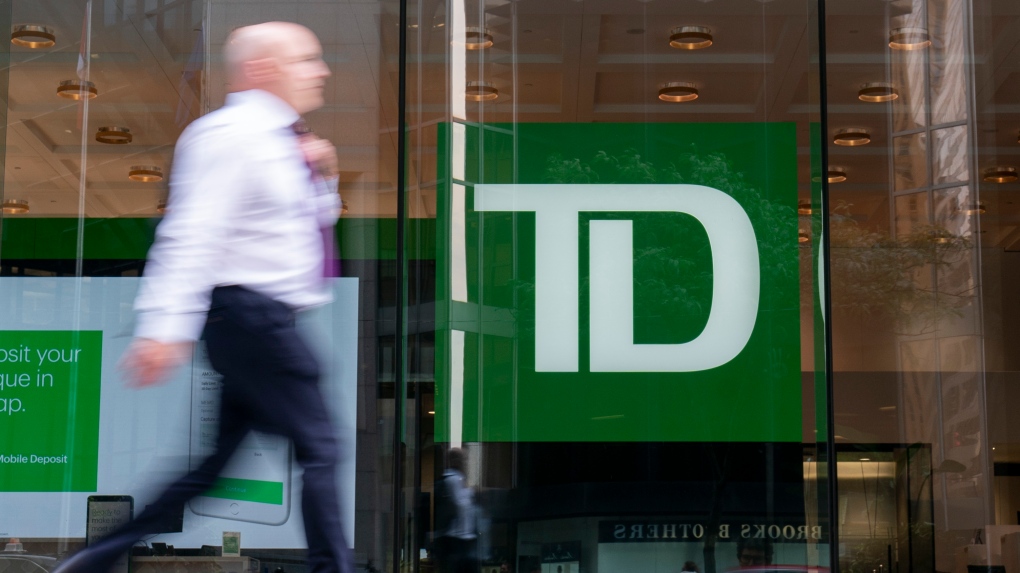 A person makes their way past a Toronto-Dominion Bank in the Financial District of Toronto on August 14, 2023. THE CANADIAN PRESS/Spencer Colby