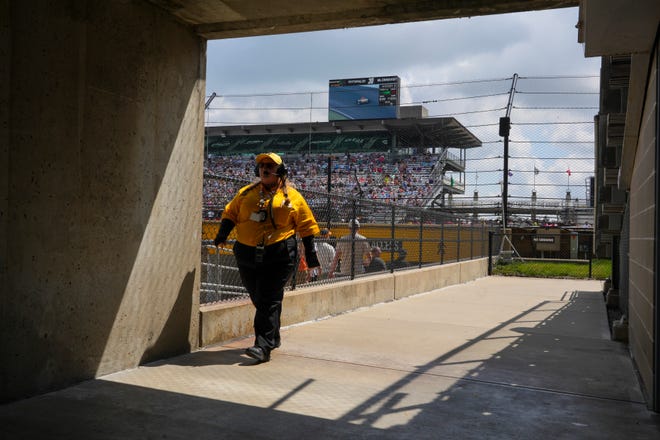 A yellow shirt IMS employee walks away from the stands, Saturday, May 18, 2024, during qualifying for the 108th running of the Indianapolis 500 at Indianapolis Motor Speedway.