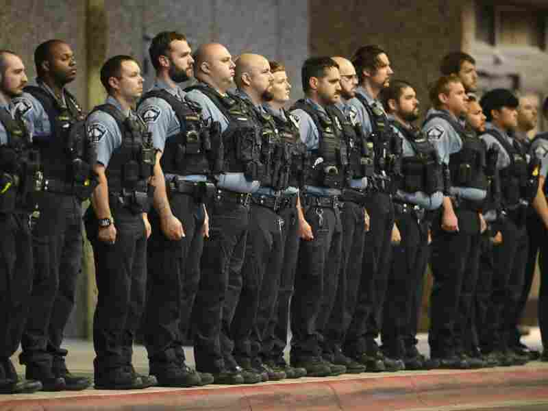 Members of law enforcement gather outside Hennepin County Medical Center in Minneapolis on Thursday.