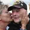 World War II veteran Gene Kleindl, age 102, from Rockford, Ill., receives a kiss from Chantell Boivin while leaving the Normandy American Cemetery on June 4 in Colleville-sur-Mer, France. Kleindl, a medic in the U.S. Army's 90th Infantry Division, arrived on the beaches of Normandy on D-Day.