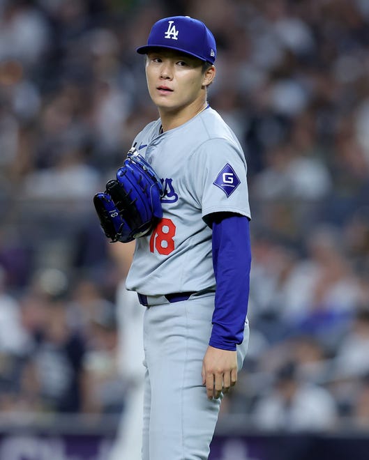 Jun 7, 2024; Bronx, New York, USA; Los Angeles Dodgers starting pitcher Yoshinobu Yamamoto (18) reacts after the seventh inning against the New York Yankees at Yankee Stadium. Mandatory Credit: Brad Penner-USA TODAY Sports