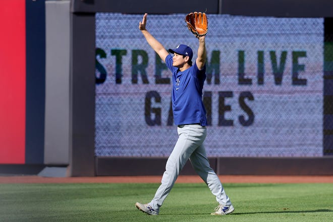 Jun 7, 2024; Bronx, New York, USA; Los Angeles Dodgers designated hitter Shohei Ohtani (17) reacts towards fans as he throws in the outfield before a game against the New York Yankees at Yankee Stadium. Mandatory Credit: Brad Penner-USA TODAY Sports