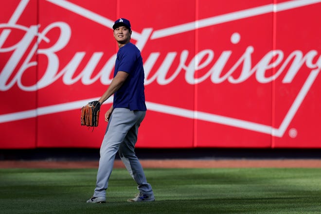 Jun 7, 2024; Bronx, New York, USA; Los Angeles Dodgers designated hitter Shohei Ohtani (17) warms up in the outfield before a game against the New York Yankees at Yankee Stadium. Mandatory Credit: Brad Penner-USA TODAY Sports