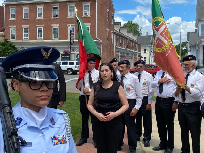 Rachel Ferreira Silva, center, sings both the Portuguese and American national anthems during the Taunton Day of Portugal flag raising ceremony on Saturday, June 8 2024.