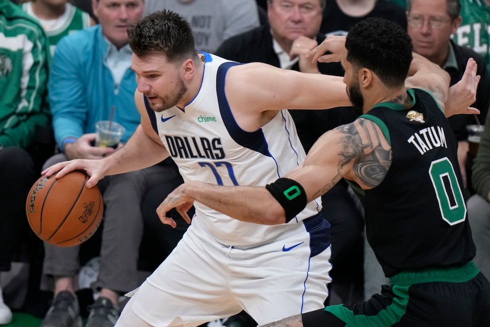 Dallas Mavericks guard Luka Doncic tries to drive past Boston Celtics forward Jayson Tatum (0)...