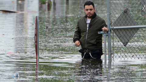 Francisco Lopez stands near the flooded parking lot of his apartment building, Thursday, June 13, 2024, in Hallandale, Florida. (AP Photo/Marta Lavandier)