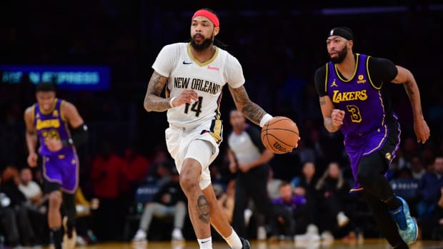 Feb 9, 2024; Los Angeles, California, USA; New Orleans Pelicans forward Brandon Ingram (14) moves the ball up court ahead of Los Angeles Lakers forward Anthony Davis (3) during the second half at Crypto.com Arena. Mandatory Credit: Gary A. Vasquez-USA TODAY Sports