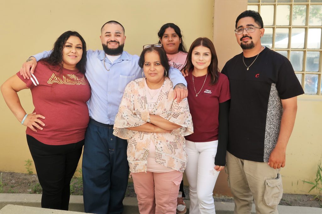 A family, one of them incarcerated, at a visiting event.