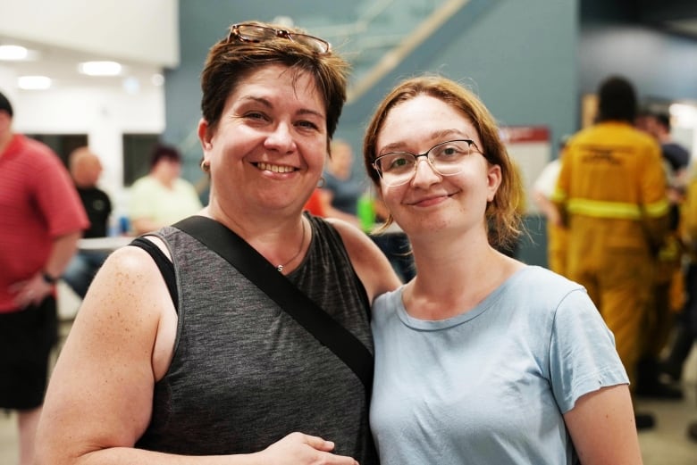 Woman and younger daughter standing side by side