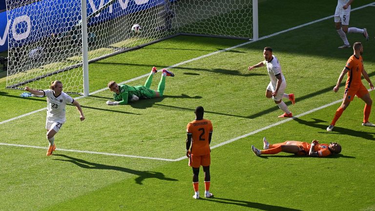 Patrick Wimmer wheels away to celebrate after Austria take the lead against the Netherlands through a Donyell Malen own goal