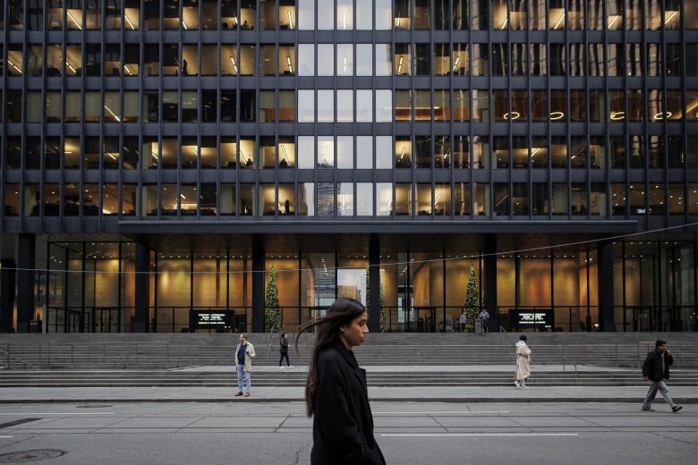 A woman walks through Toronto's downtown.