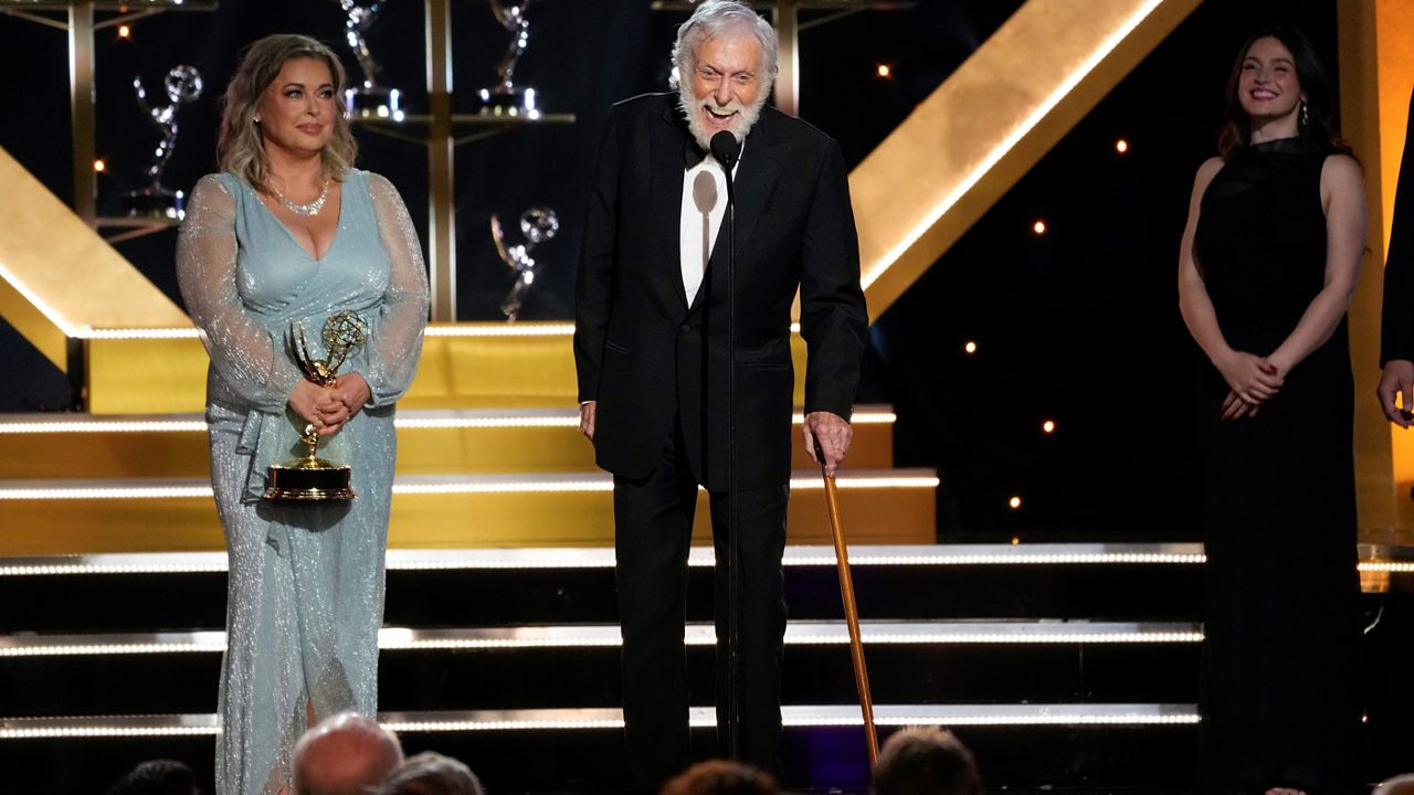 Dick Van Dyke accepts the award for outstanding guest performance in a daytime drama series for "Days of our Lives" during the 51st Daytime Emmy Awards on Friday, June 7, 2024, at the Westin Bonaventure in Los Angeles. Arlene Silver looks on from left. (AP Photo/Chris Pizzello)