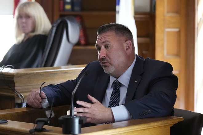 Witness Brian Higgins answers a question from prosecutor Adam Lally regarding text messages between Higgins and defendant Karen Read, during Read&apos;s trial in Norfolk Superior Court, Friday, May 24, 2024, in Dedham, Mass. Read, 44, is accused of running into her Boston police officer boyfriend with her SUV in the middle of a nor&apos;easter and leaving him for dead after a night of heavy drinking. (AP Photo/Charles Krupa, Pool)