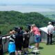 Visitors watch North Korean side from the Unification Observation Post in Paju, South Korea, near the border with North Korea, Tuesday, June 18, 2024. South Korean soldiers fired warning shots to repel North Korean soldiers who temporarily crossed the rivals' land border Tuesday for the second time this month, South Korea's military said. (AP Photo/Ahn Young-joon)