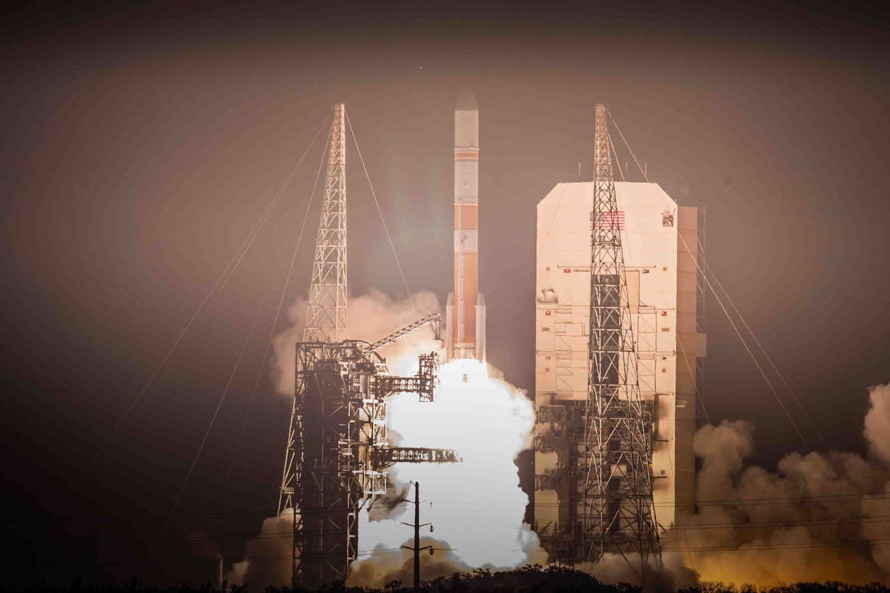 Flames and smoke billow from underneath a rocket as it lifts off from a launch pad.