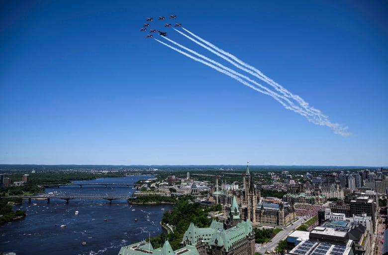 Royal Canadian Air Force Snowbirds and a CF-18 fly over Parliament Hill during a flypast celebrating the RCAF centennial, on Canada Day in Ottawa, on Monday, July 1, 2024.