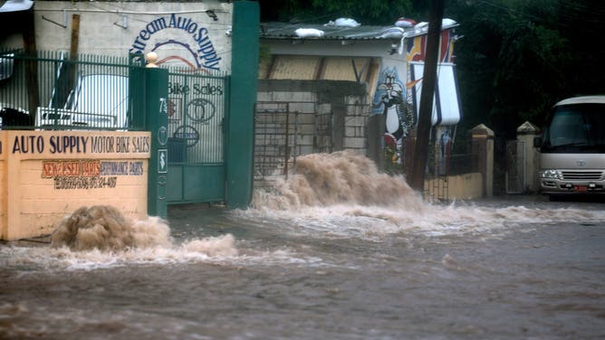 KINGSTON, JAMAICA - JULY 03: Flood waters pour onto the street as Hurricane Beryl passes through the area on July 03, 2024, in Kingston, Jamaica. Beryl has caused widespread damage in several island nations as it continues to cross the Caribbean. (Photo by Joe Raedle/Getty Images)