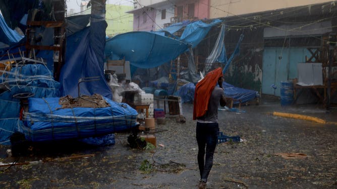 KINGSTON, JAMAICA - JULY 03: A person makes their way through the wind and rain from Hurricane Beryl on July 03, 2024, in Kingston, Jamaica. Beryl has caused widespread damage in several island nations as it continues to cross the Caribbean. (Photo by Joe Raedle/Getty Images)