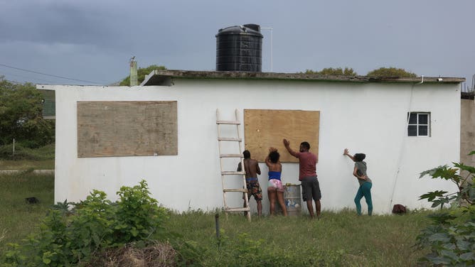 KINGSTON, JAMAICA - JULY 03: People place plywood over windows as they make last-minute preparations for the arrival of Hurricane Beryl on July 03, 2024 in Kingston, Jamaica. Category 4 storm Beryl has caused widespread damage in several island nations as it continues to cross the Caribbean. (Photo by Joe Raedle/Getty Images)