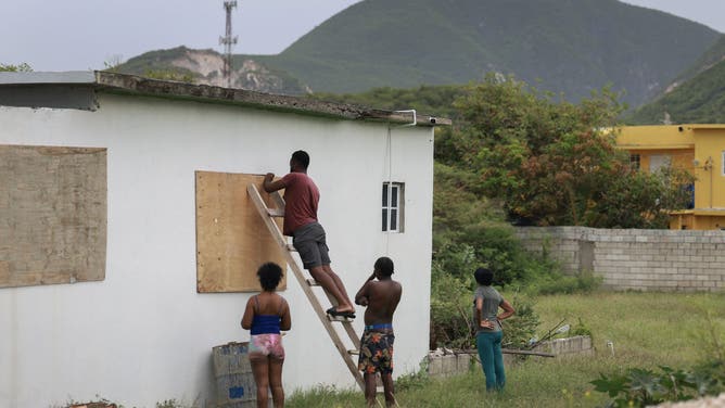 KINGSTON, JAMAICA - JULY 03: People place plywood over windows as they make last-minute preparations for the arrival of Hurricane Beryl on July 03, 2024 in Kingston, Jamaica. Category 4 storm Beryl has caused widespread damage in several island nations as it continues to cross the Caribbean. (Photo by Joe Raedle/Getty Images)