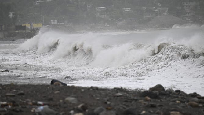 High waves crash along the beach in Kingston, Jamaica, before the arrival of Hurricane Beryl on July 3, 2024. Beryl churned towards Jamaica on July 3, with forecasters warning of potentially deadly winds and storm surge, after at least seven people were killed and widespread destruction was reported across the southeastern Caribbean. The powerful hurricane, which is rare so early in the Atlantic season, was expected to pass over Jamaica around midday as a 