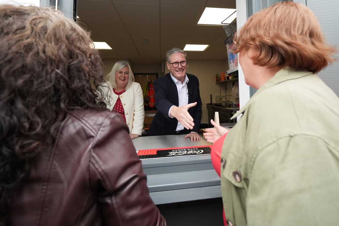 Labour leader Keir Starmer makes tea for supporters on Tuesday in Nottingham, United Kingdom. Maintaining a large lead over the Conservatives, Starmer prioritizes his closing campaign efforts to win back voters in areas that were once Labour's traditional strongholds.