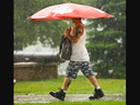 A man walks through Victoria Park amid a downpour on July 6, 2023. Mike Hensen/ The London Free Press