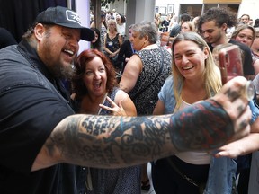 Jelly Roll takes a photo with some fans Tuesday while at the Royal Ottawa Hospital to perform a mini concert.