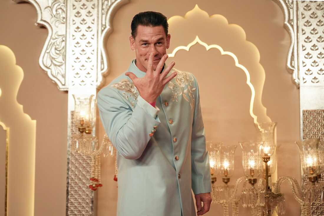 American actor and professional wrestler John Cena gestures as he arrives at the wedding in Mumbai on Friday.