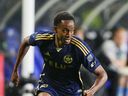 Vancouver Whitecaps forward Ali Ahmed runs against the Seattle Sounders during the second half of an MLS soccer match on May 18, 2024, in Seattle.