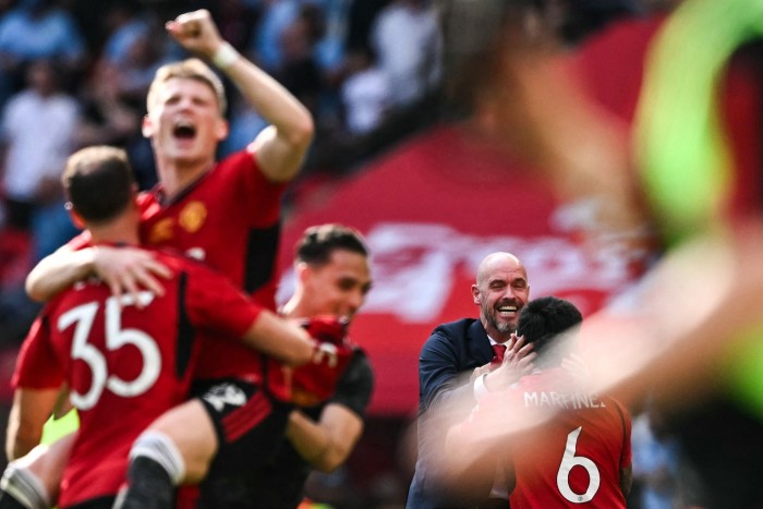 Manchester United’s Dutch manager Erik ten Hag, centre, celebrates with his players after they beat Manchester City to win the English FA Cup final