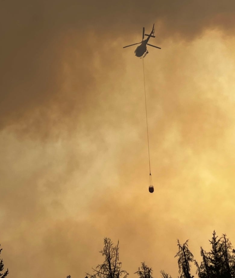 A firefighter against orange smoke. 