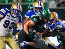 Saskatchewan Roughriders running back AJ Ouellette (45) runs the football against Winnipeg Blue Bombers during the second half of CFL football action in Regina, on Friday, July 19, 2024.