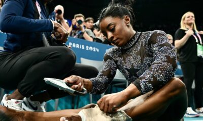 Simone Biles hurts her leg in Olympic gymnastics qualifying but finishes 1st anyway