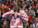 Silver medallist Canada's Summer Mcintosh reacts on the podium of the women's 400m freestyle swimming event at the Paris 2024 Olympic Games.