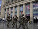 Soldiers patrol outside Gare du Nord train station at the 2024 Summer Olympics, Friday, July 26, 2024, in Paris, France. Hours away from the grand opening ceremony of the Olympics, high-speed rail traffic to the French capital was severely disrupted on Friday by what officials described as 